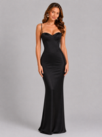 Woman wearing a black evening gown against a gray background