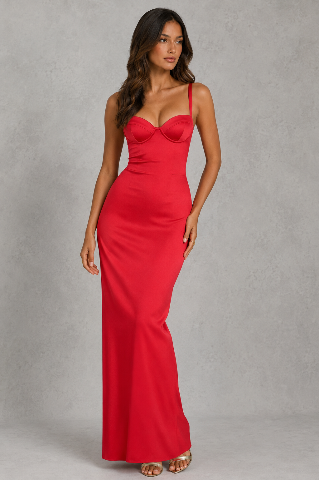 Woman wearing a red evening gown against a gray background