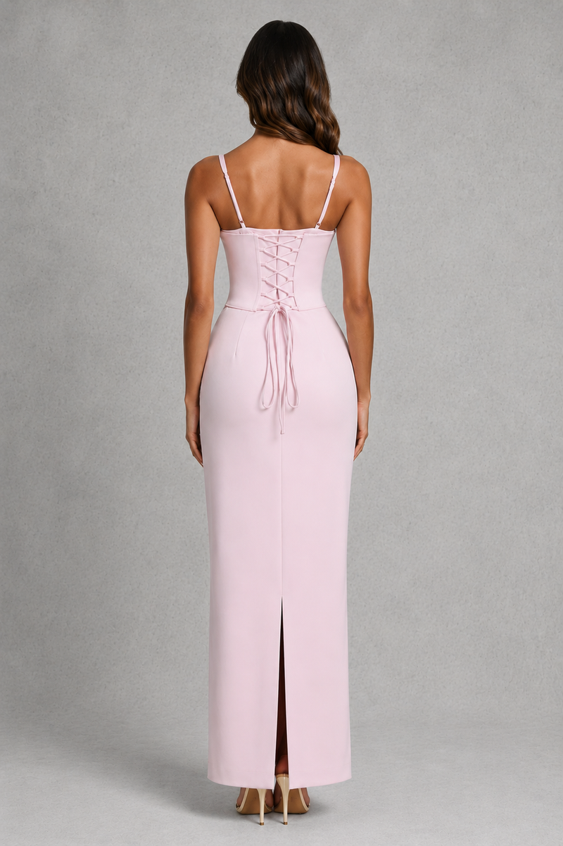 Pink dress with thin straps and a slit on a gray background