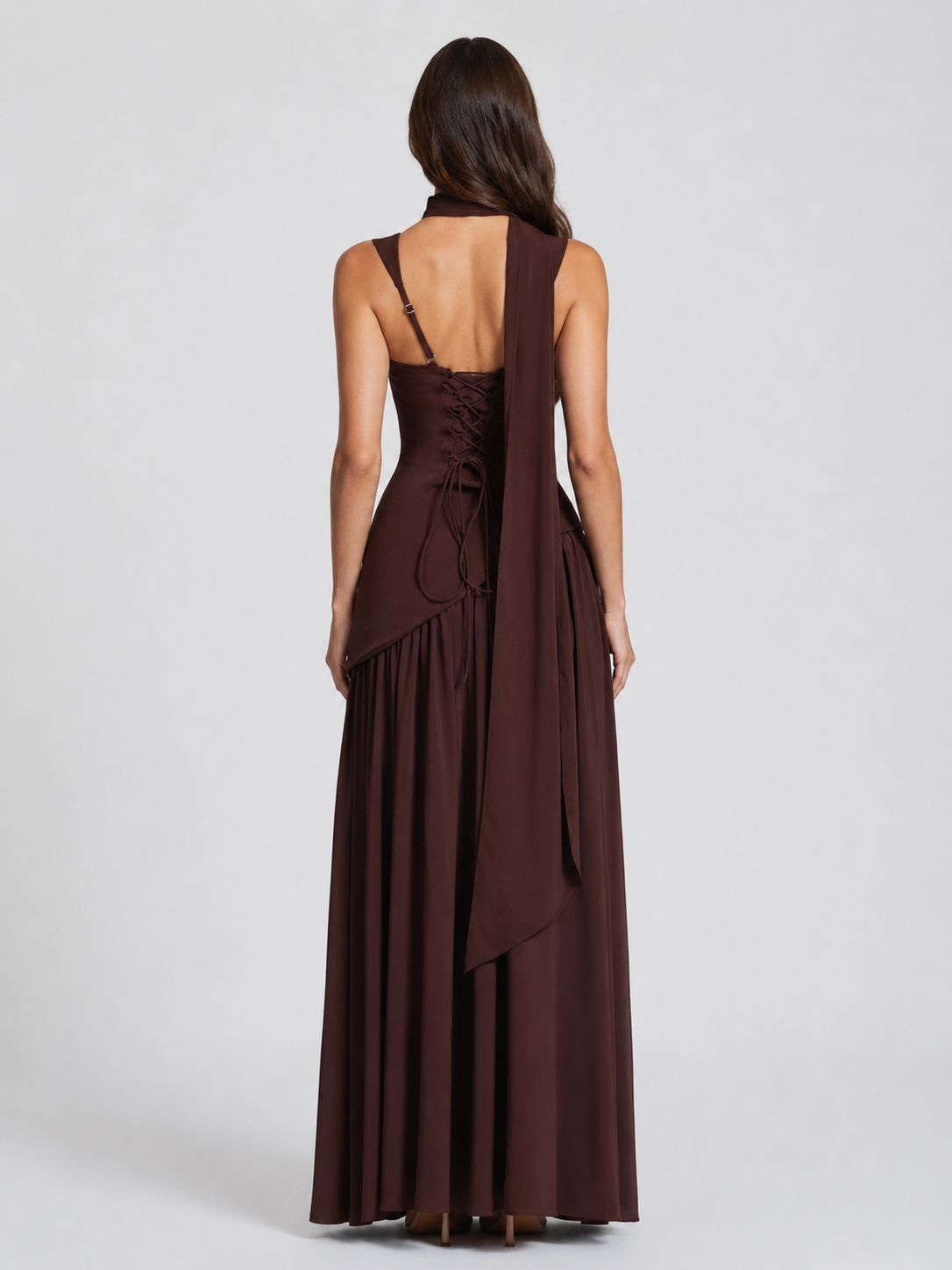 Brown evening gown with a draped design on a white background