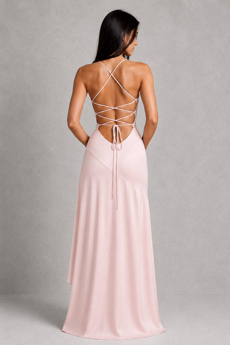 Woman wearing a pink dress with open back on a gray background