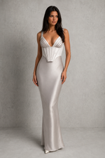 Woman wearing a silver evening gown against a gray background