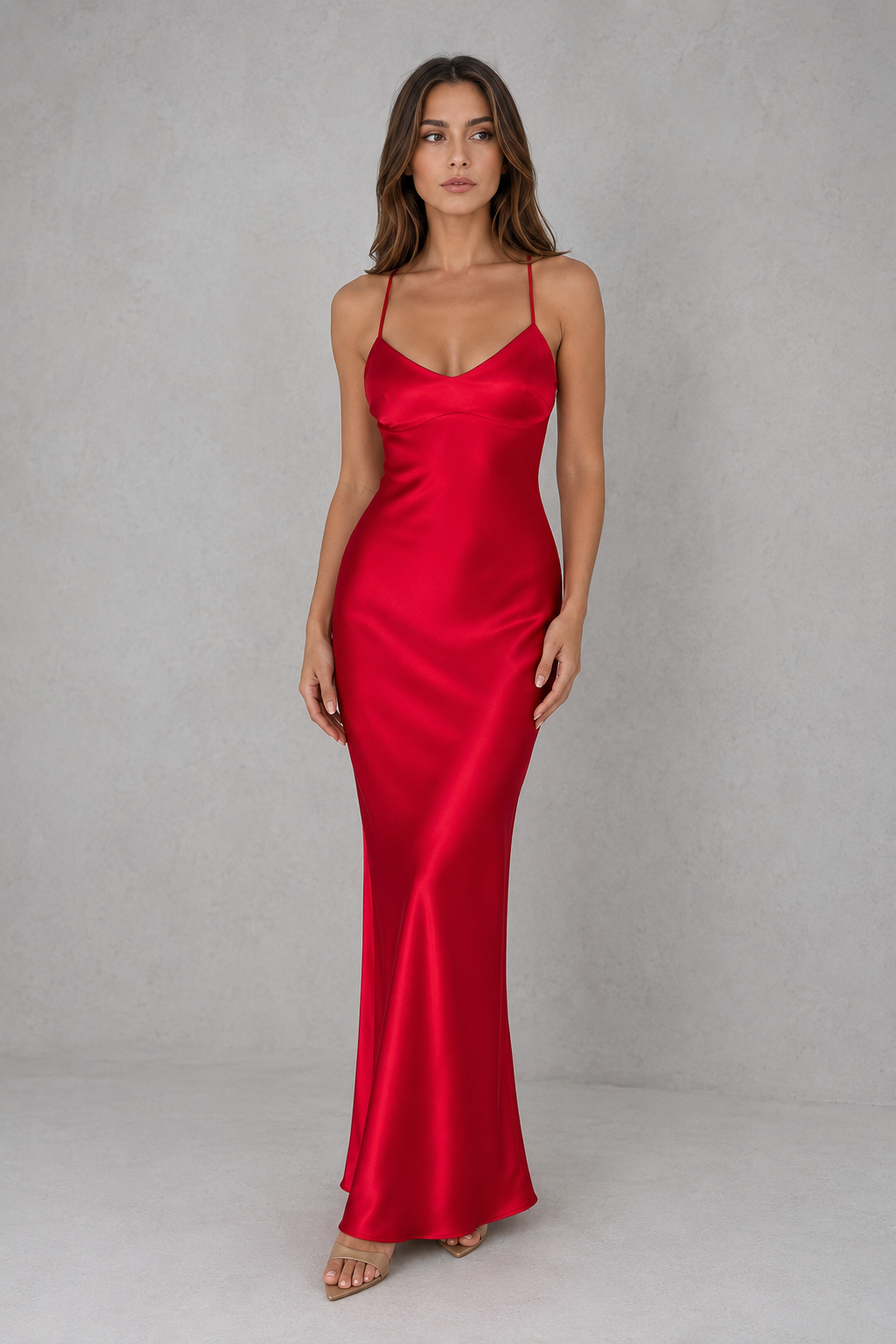 Woman wearing a red satin dress against a gray background
