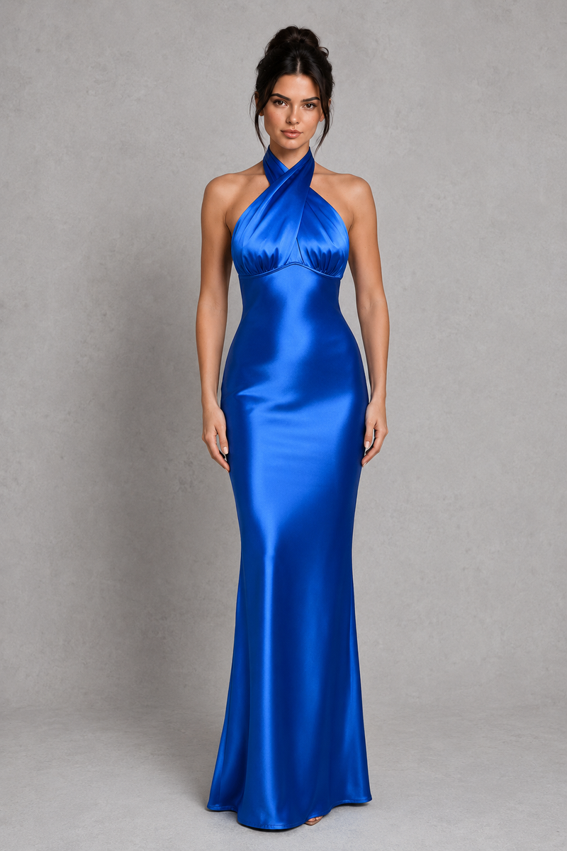 Woman wearing a blue satin evening gown against a gray background