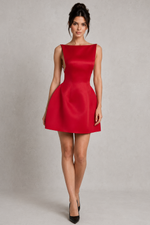 Woman wearing a red dress against a plain background
