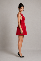 Woman wearing a red dress against a gray background