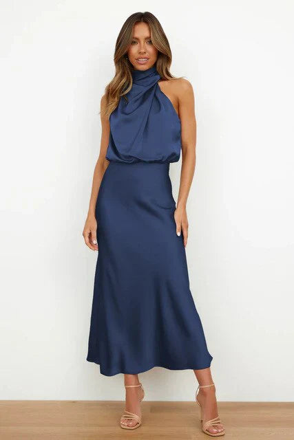 Woman wearing a blue dress against a white background
