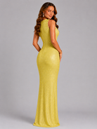 Woman wearing a yellow evening gown against a gray background