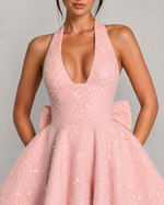 Pink sequin dress with a plunging neckline on a gray background