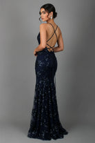 Navy blue sequin evening gown with criss-cross back on a gray background