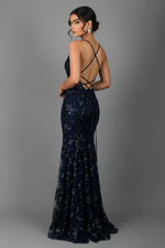 Navy blue sequin evening gown with criss-cross back on a gray background