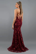 Burgundy sequin evening gown with a backless design on a gray background