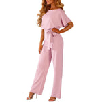 Pink jumpsuit worn by a model on a white background