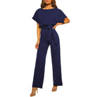 Navy blue jumpsuit worn by a model on a white background