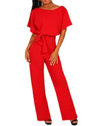 Red jumpsuit worn by a model on a white background