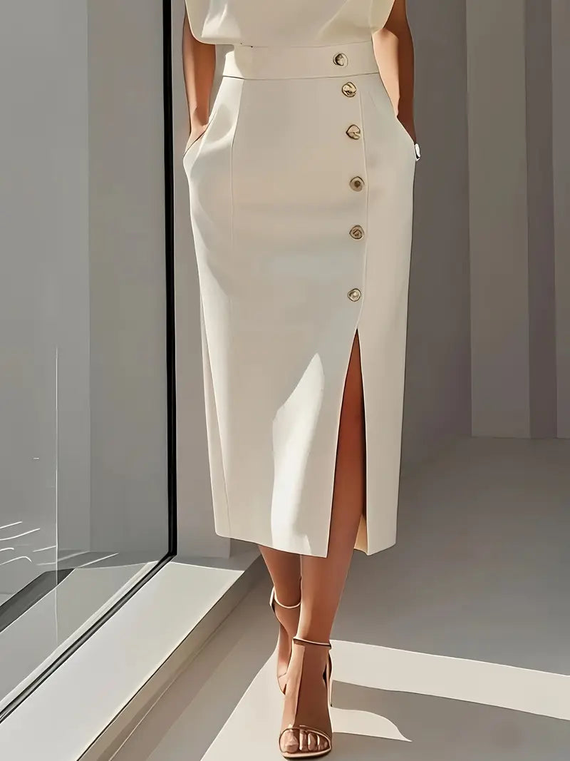 Person wearing a white skirt with button details in a minimalistic setting