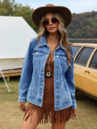 Woman wearing a denim jacket and brown hat outdoors with a tent and vehicle in the background