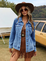 Woman wearing a denim jacket and brown hat outdoors with a tent and vehicle in the background
