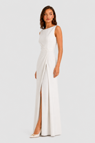 Women’s sleeveless maxi dress with boat neckline, draped waist detail, and wrap-style front panel