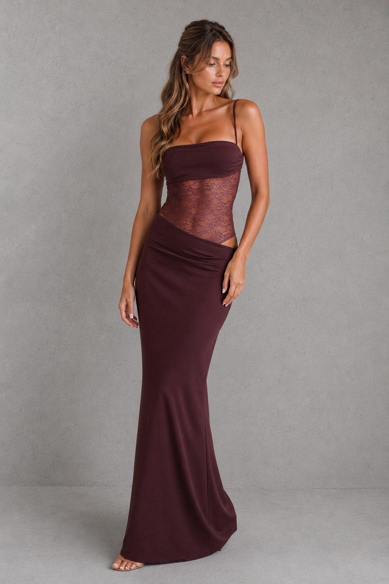 Woman wearing a burgundy evening gown against a gray background