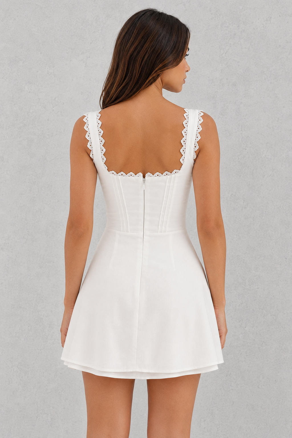 White dress with lace details on a gray background