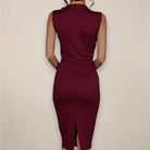 Maroon dress with a high slit on a beige background