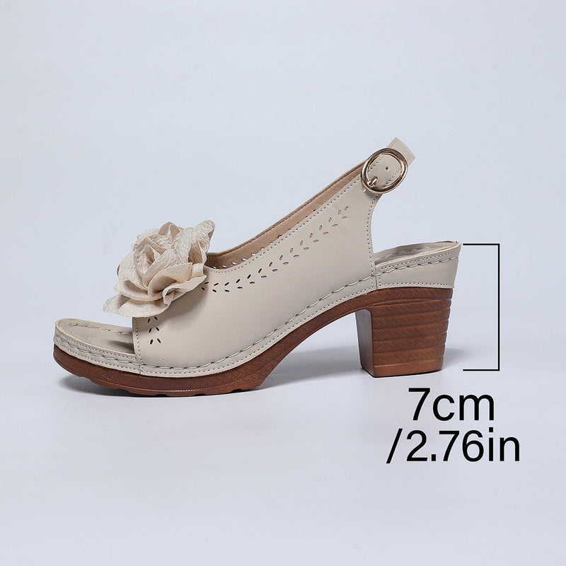 Beige sandal with wooden heel and flower detail on a light gray background