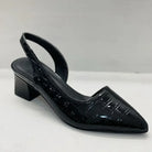 Black patent leather slingback shoe on a white background