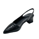 Black patent leather slingback shoe on a white background