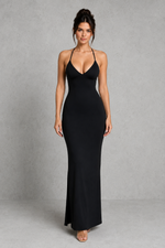 Woman wearing a black evening gown against a gray background