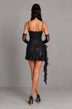 Black lace dress with sheer sleeves on a gray background