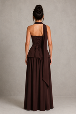 Woman wearing a brown evening gown with a plain background