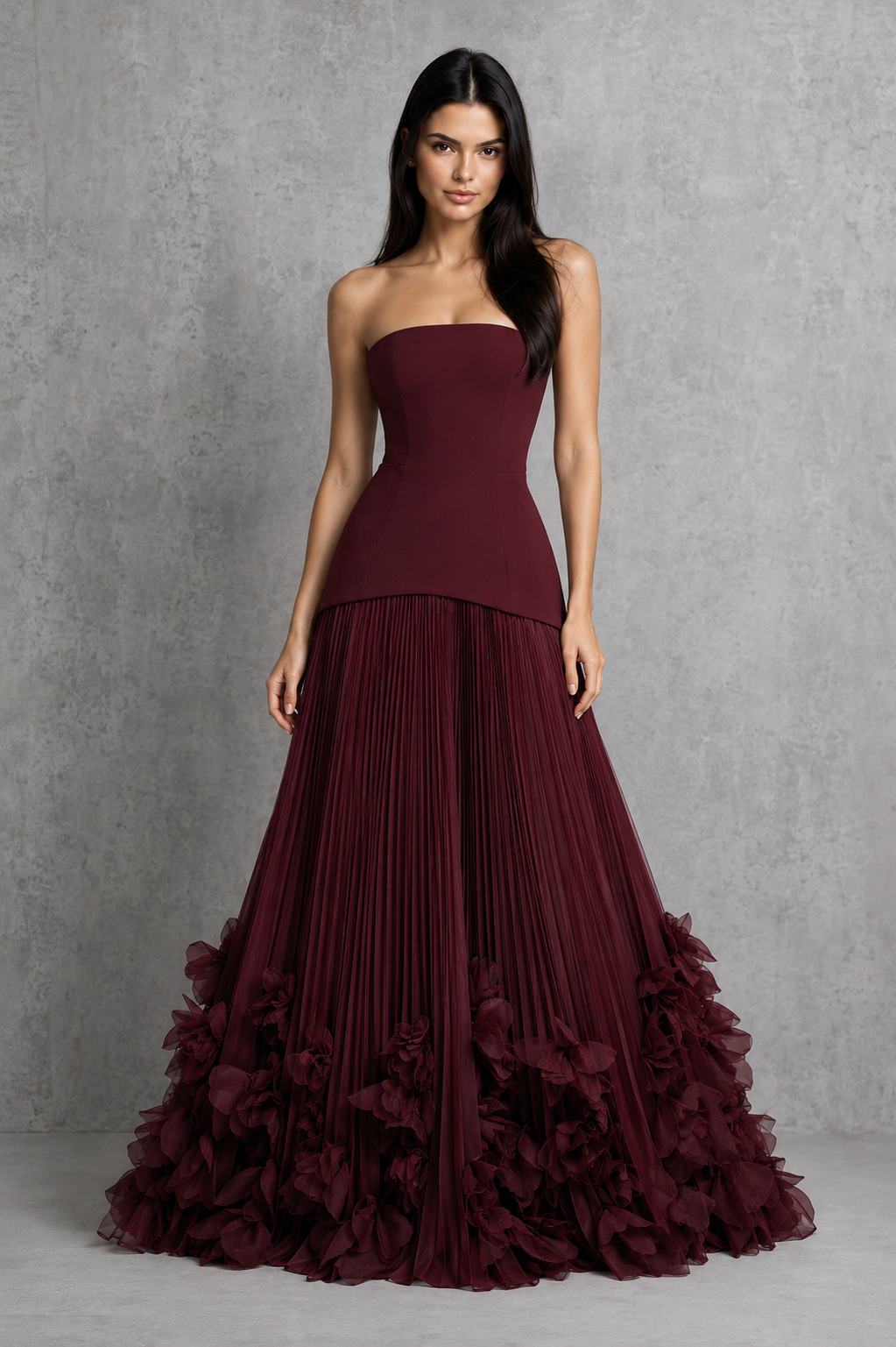 Women’s cherry lacquer strapless corset gown with a lace-up back, pleated full skirt, and handcrafted floral appliqué hem