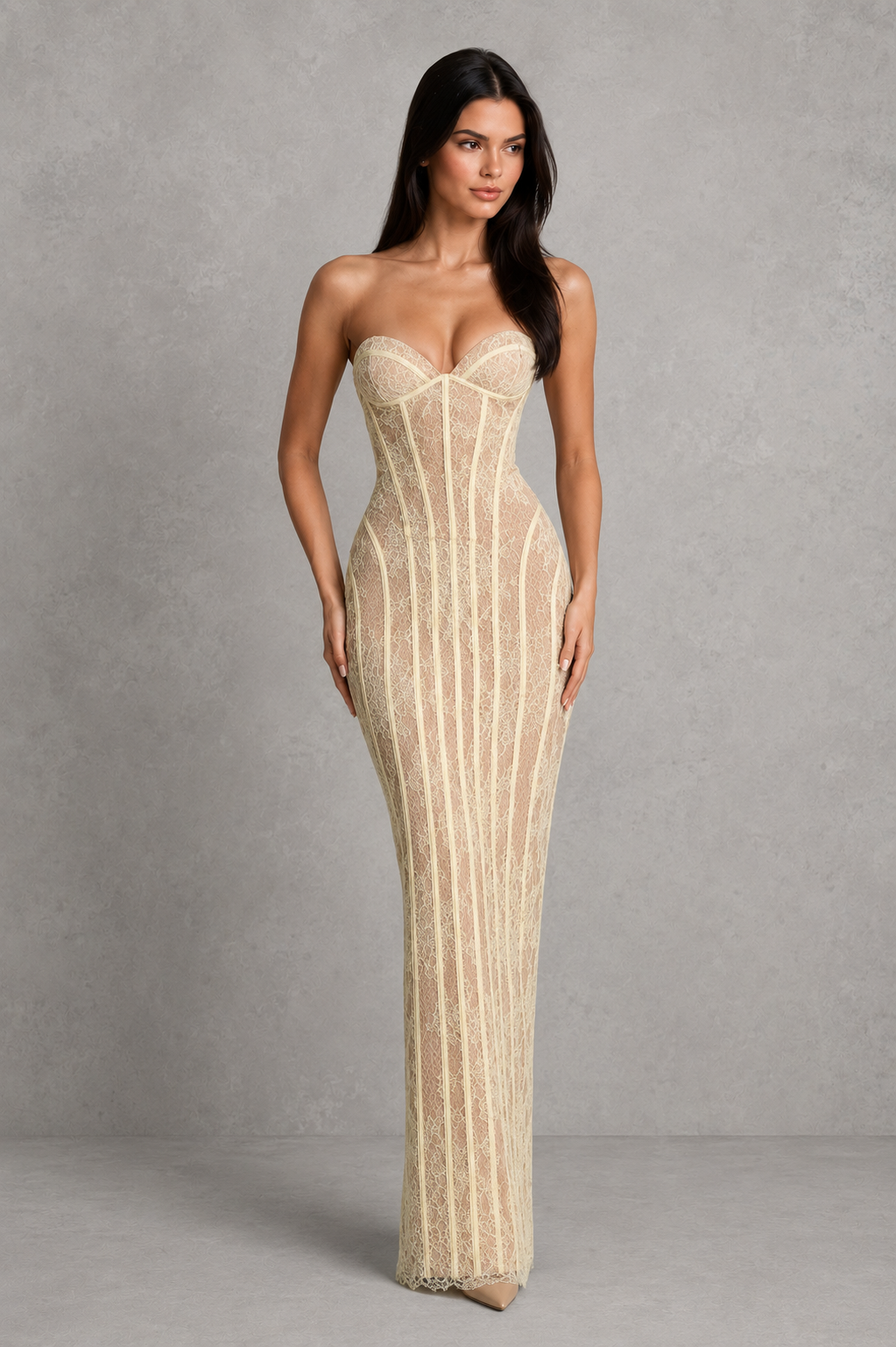 Woman wearing a strapless, high-waisted dress with vertical stripes against a gray background