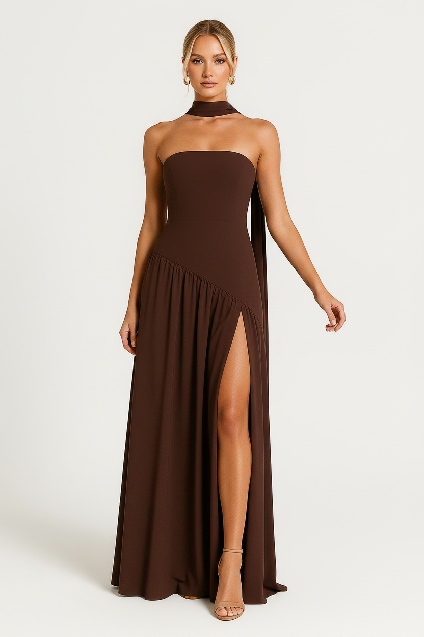 Woman wearing a brown strapless gown with a slit on a white background