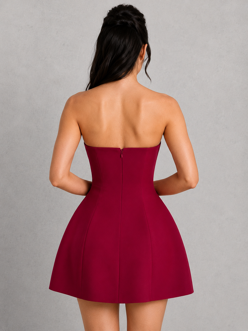 Red strapless dress worn by a person on a gray background