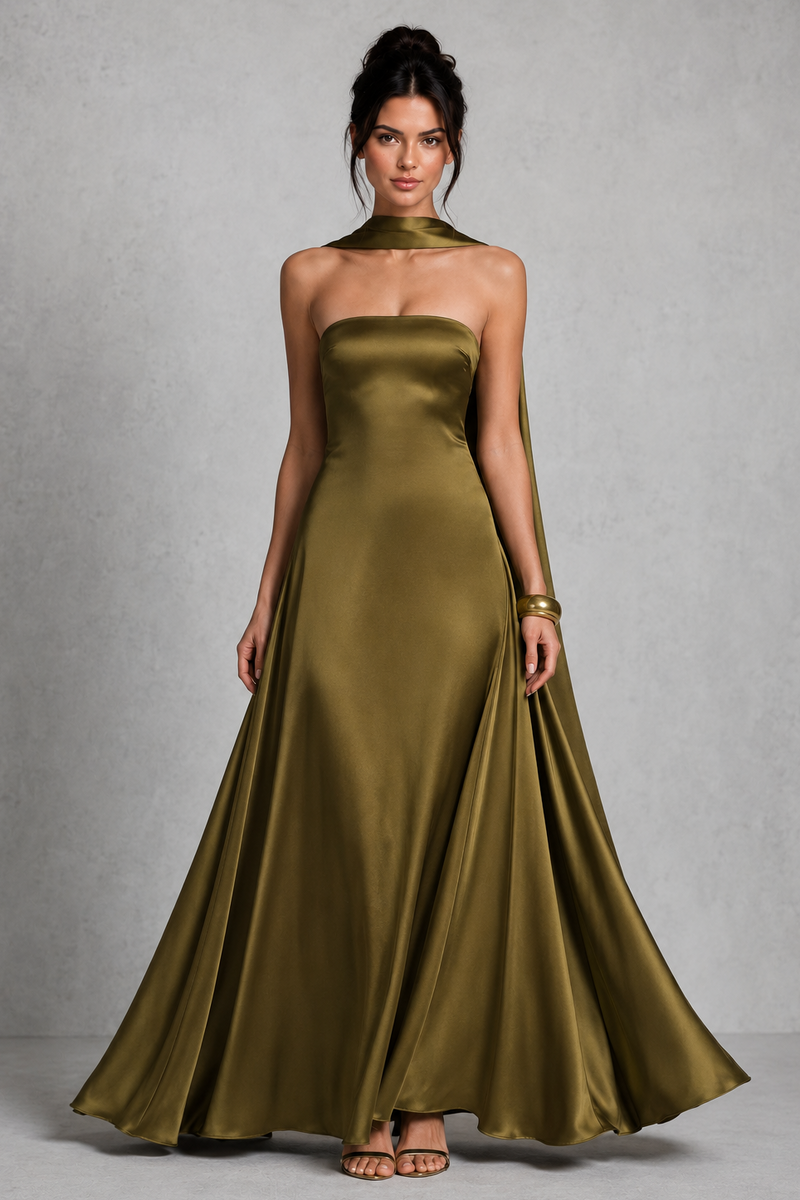Woman wearing a green strapless gown against a gray background