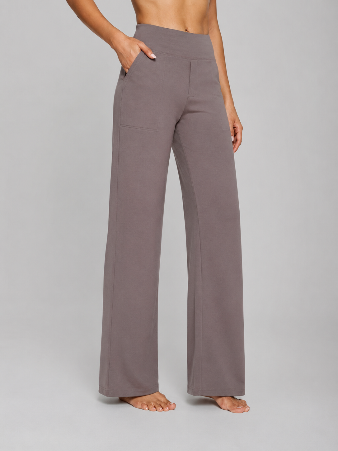 Person wearing gray wide-leg pants on a plain background