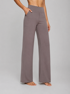 Person wearing gray wide-leg pants on a plain background