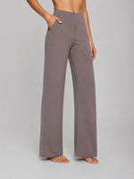 Person wearing gray wide-leg pants on a plain background