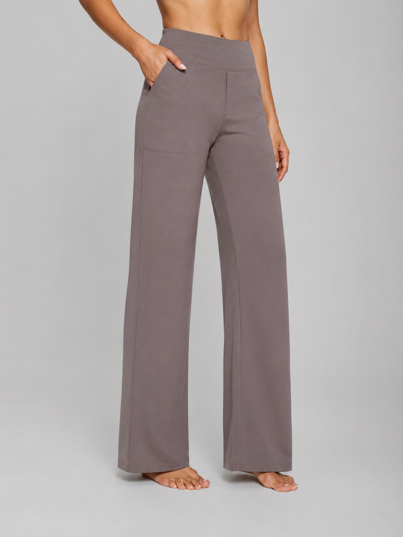 Person wearing gray wide-leg pants on a plain background