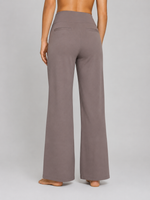 Brown wide-leg pants worn by a person on a gray background