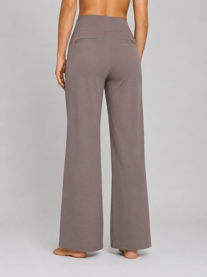 Brown wide-leg pants worn by a person on a gray background