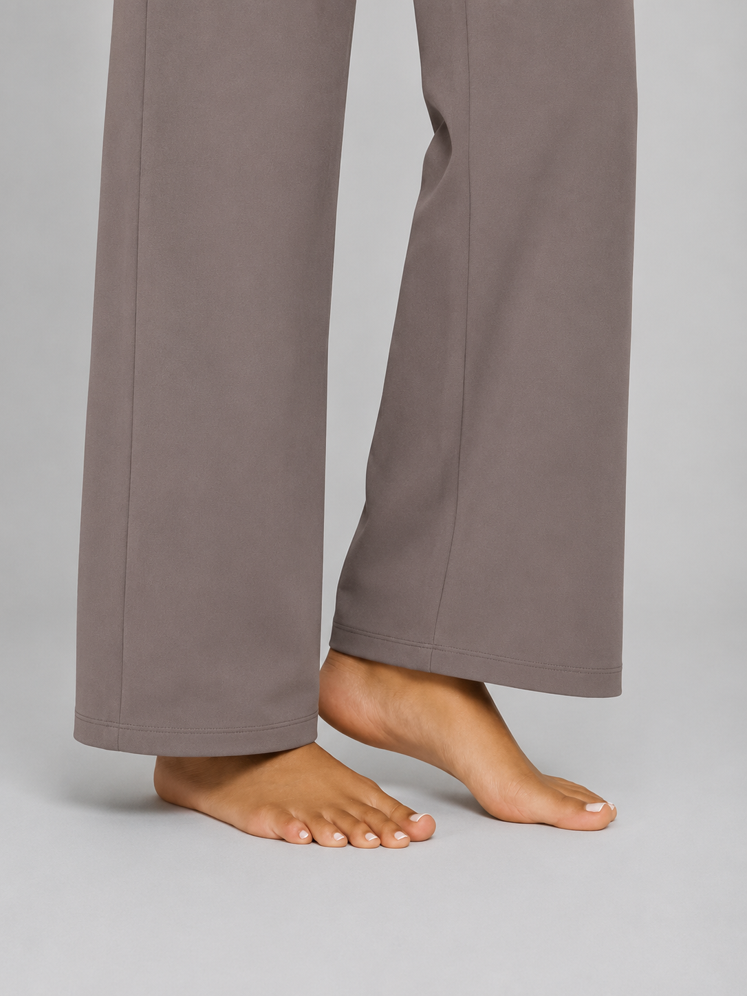 Gray pants worn by a person on a plain background