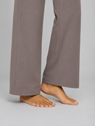 Gray pants worn by a person on a plain background