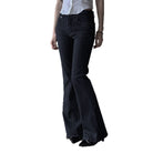 Black flared pants worn by a person on a white background