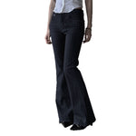 Black flared pants worn by a person on a white background