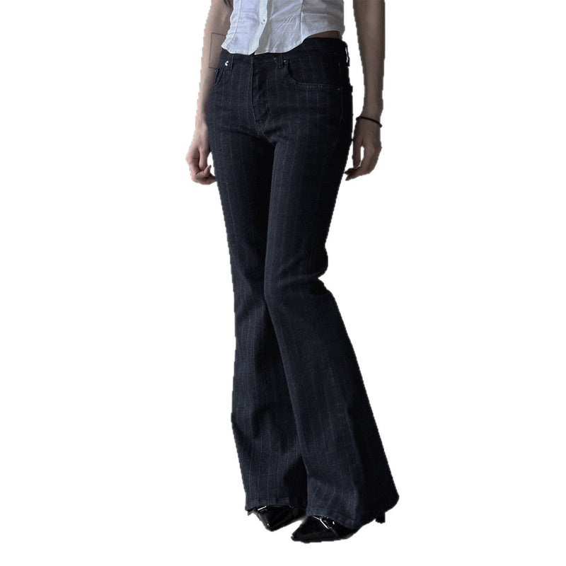 Black flared pants worn by a person on a white background