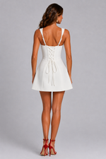 Woman wearing a white dress with a gray background