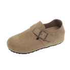 Beige suede clog shoe with a buckle on a white background